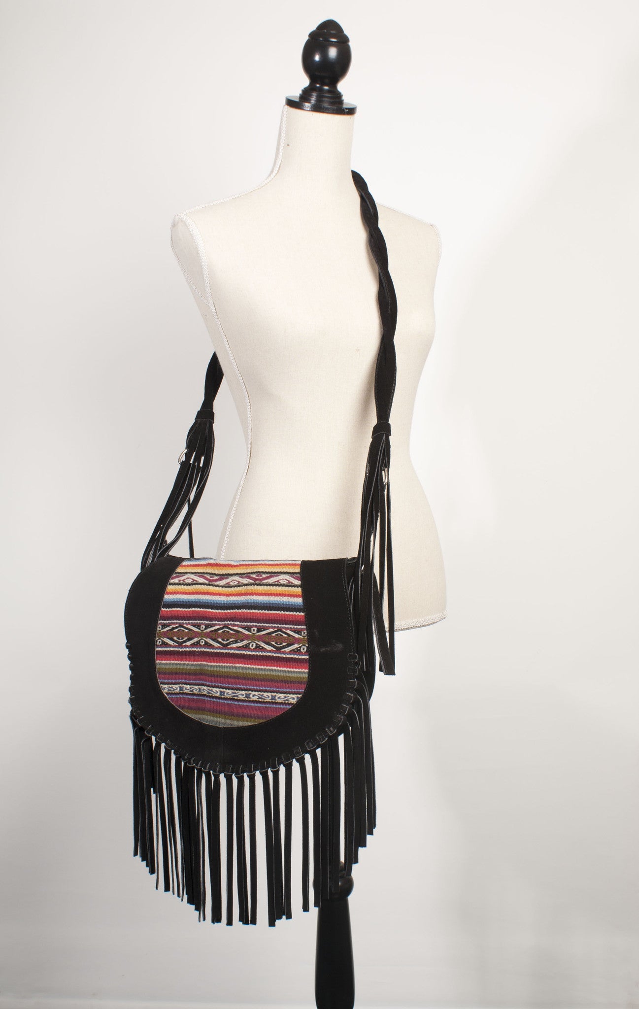 traditional textile and black suede handbag